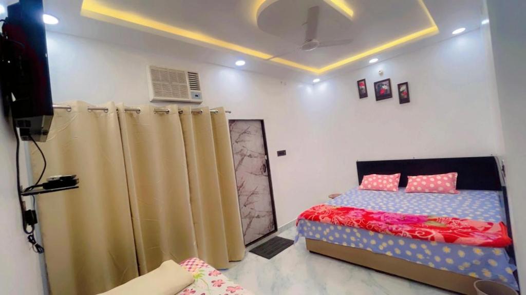 a bedroom with a bed and curtains in it at SOALTEE Near Lucknow Airport in Lucknow