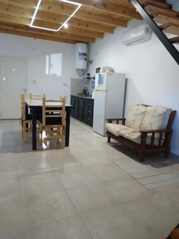 a kitchen with a couch and a table in a room at JAS departamento in General Acha