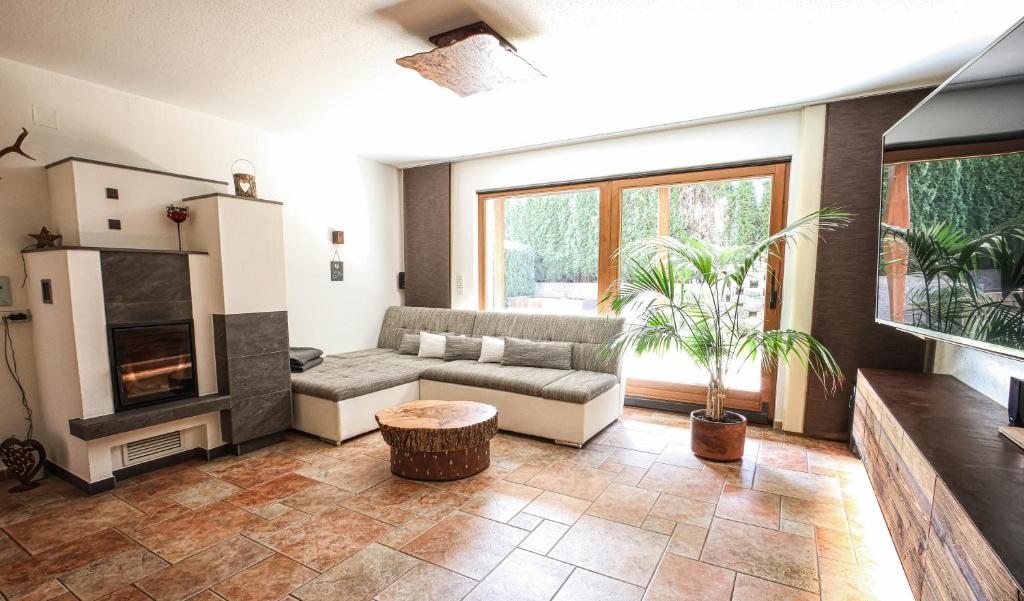 a living room with a couch and a fireplace at Gartenapartment Malea in Schlitters