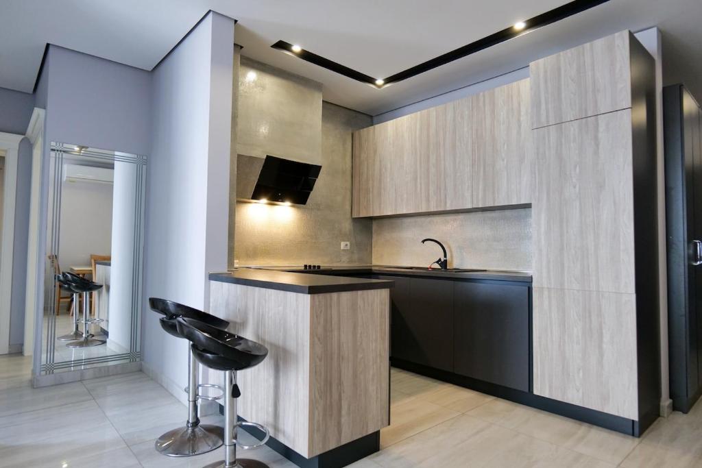 a kitchen with a sink and a bar with a stool at Olive Qerret in Golem