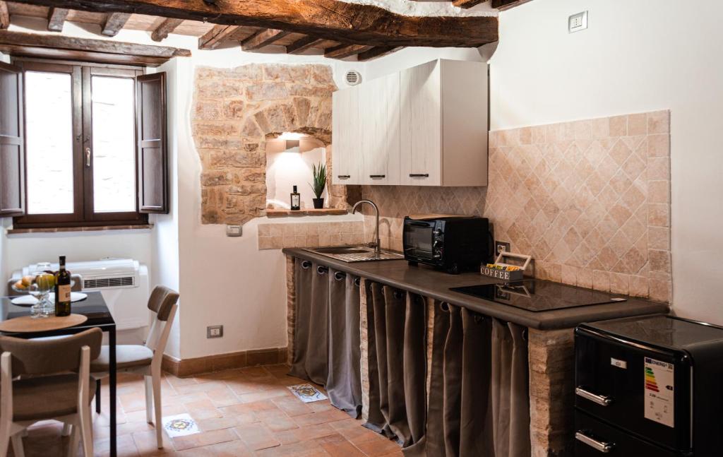a kitchen with a counter top and a table at Casa Vacanze Todi in Todi