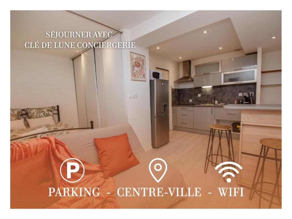 a living room with a couch and a kitchen at Ecrin Pontissalien - Studio with Parking in Pontarlier