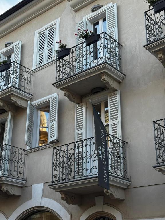 a building with balconies and a flag on it at Appartamento Rosa Rosa' in Porto SantʼElpidio