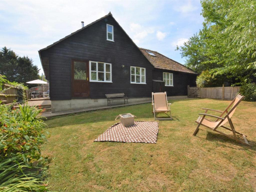 a house with a table and two chairs in the yard at 2 Bed in Sherborne oc-53673 in Chetnole