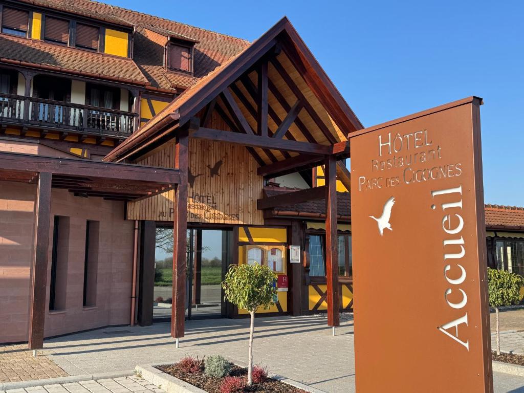 a hotel sign in front of a building at Hotel Restaurant Au Parc des Cigognes in Kintzheim