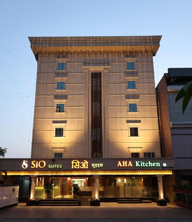 a tall building with a sign in front of it at Sio Suites in Navi Mumbai
