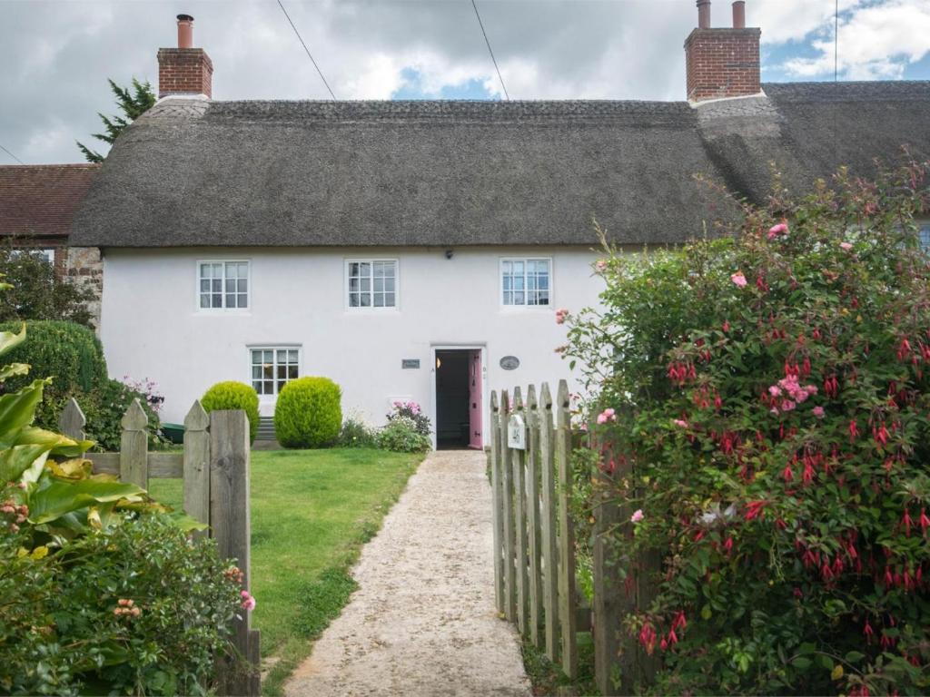 a white house with a gate and a fence at 1 Bed in Wareham oc-dc153 in Wool