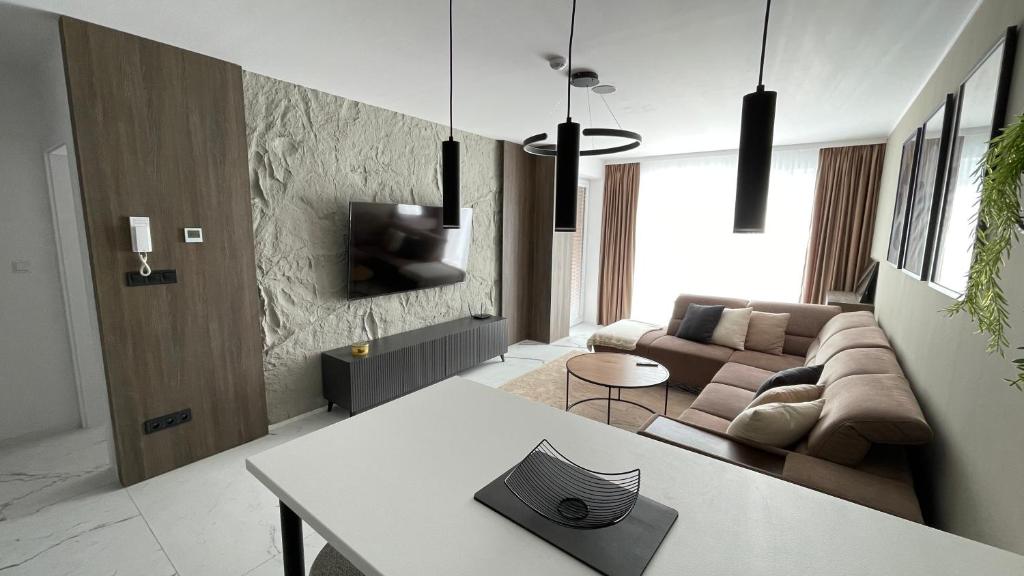 a living room with a couch and a table at Apartmán beige Bardejovské Kúpele in Bardejov