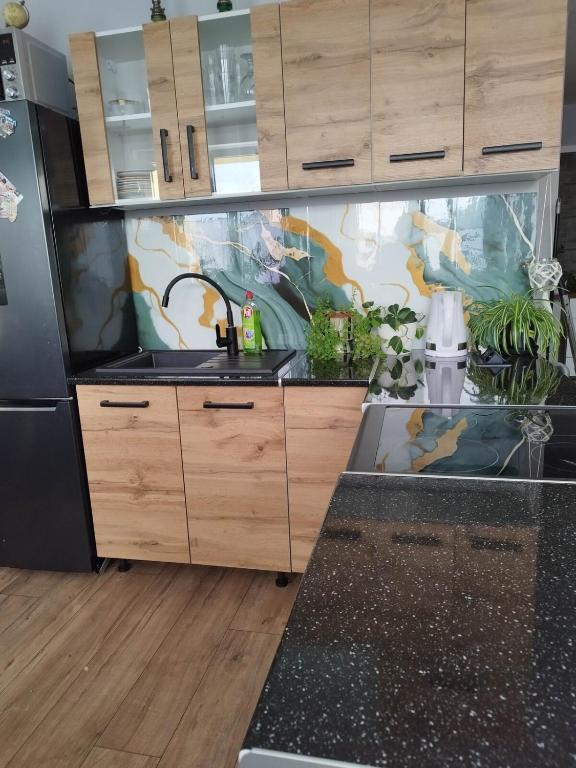 a kitchen with a fish tank in the middle at Jolanta's apartment in Hajnówka