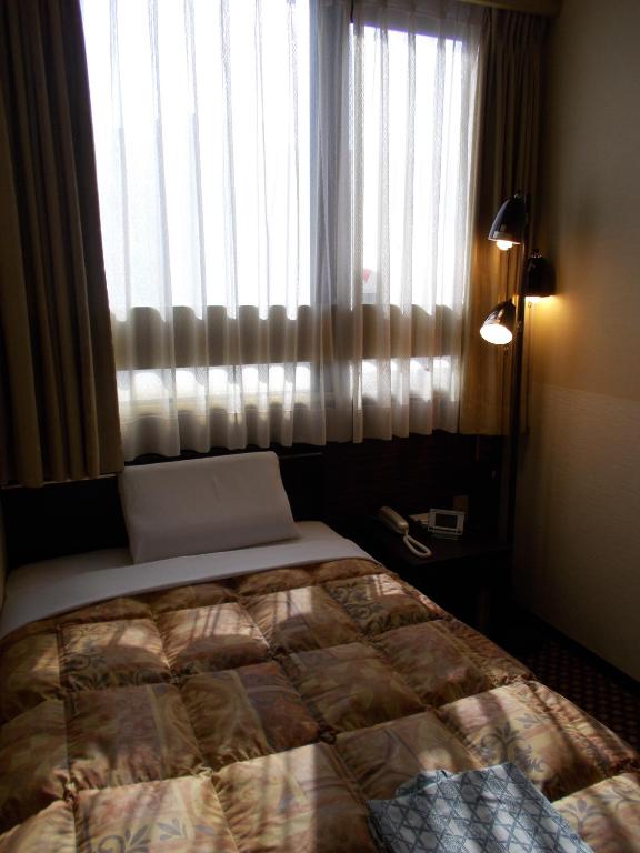 Postel nebo postele na pokoji v ubytování Hotel Matsuyama Hills