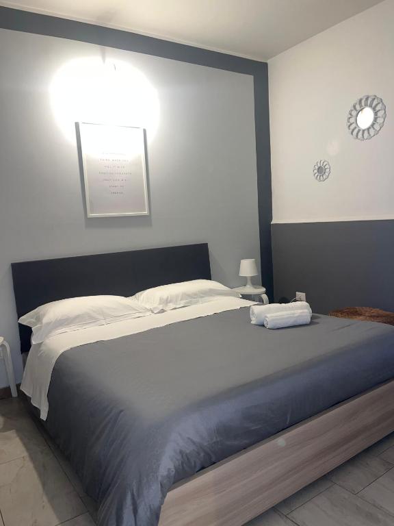 a bedroom with a bed with two towels on it at A picciridda house in Catania