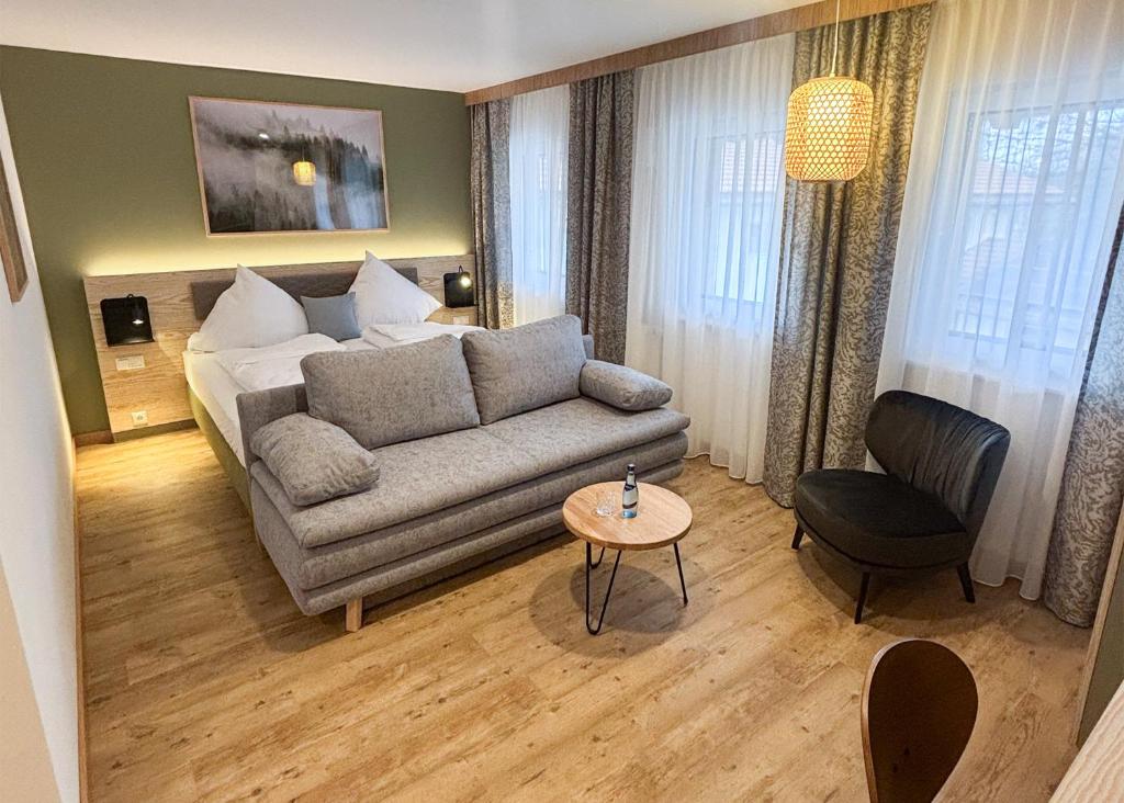 a living room with a couch and a bed at StadlTraum Falkenberg in Moosach