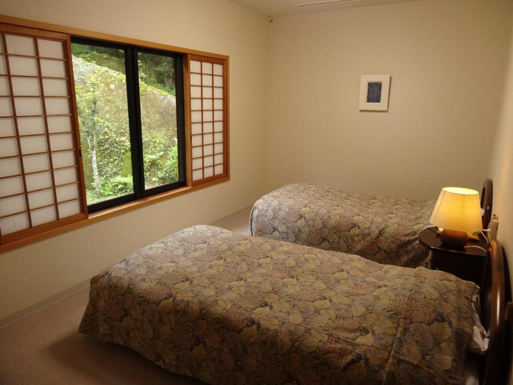 Postel nebo postele na pokoji v ubytování Auberge Funoki