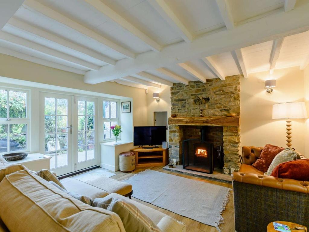 a living room with a couch and a fireplace at 3 Bed in Leyburn oc-89746 in Spennithorne