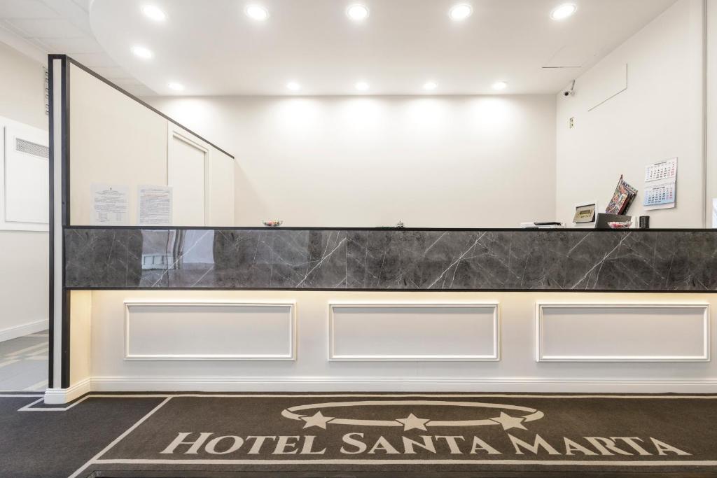 a hotel santa marina lobby with a hotel santa marina sign at Hotel Santa Marta in Pozzuoli