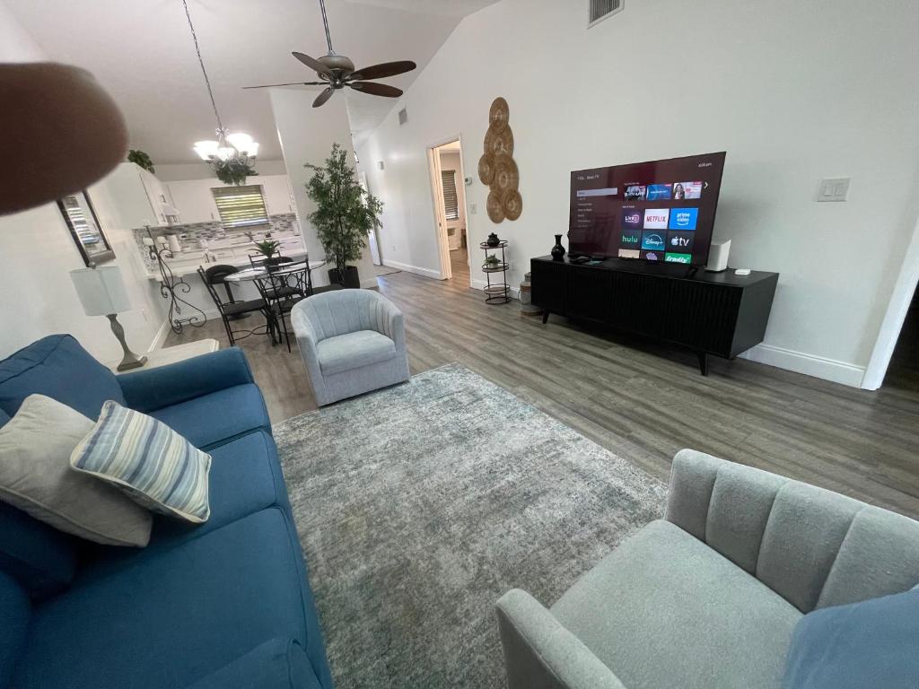 a living room with a blue couch and a flat screen tv at Perfect lodging in Lake Placid in Lake Placid
