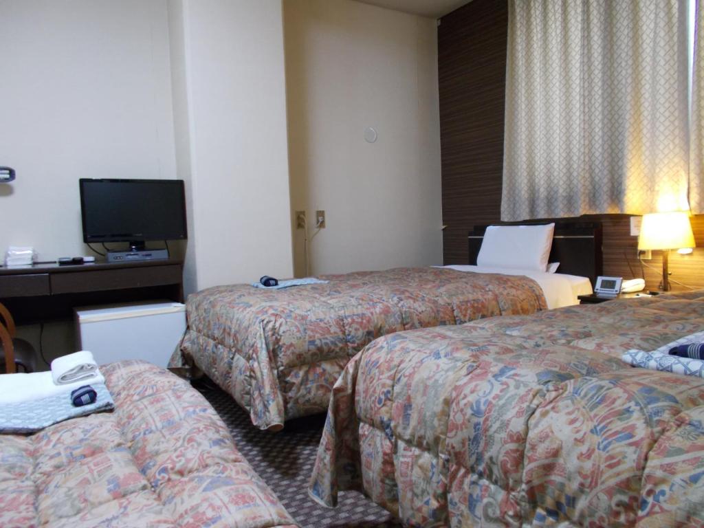 Postel nebo postele na pokoji v ubytování Hotel Matsuyama Hills
