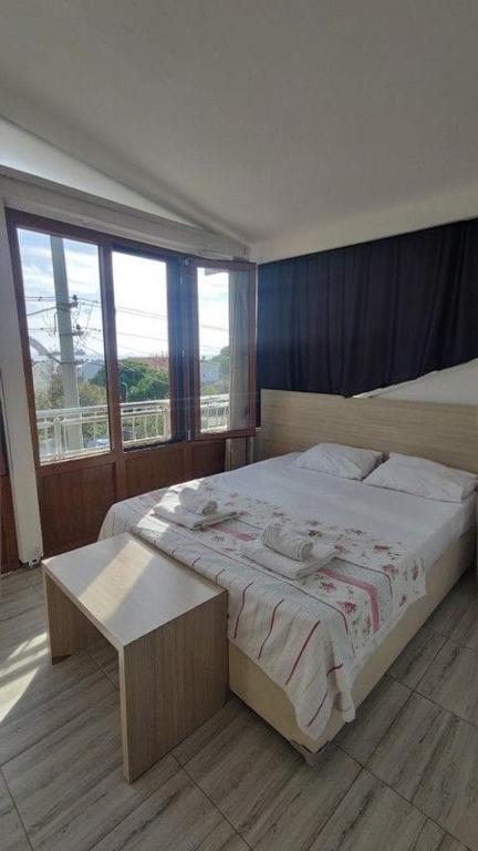 a bedroom with a large bed and a table at Midis Park Otel in Şarköy