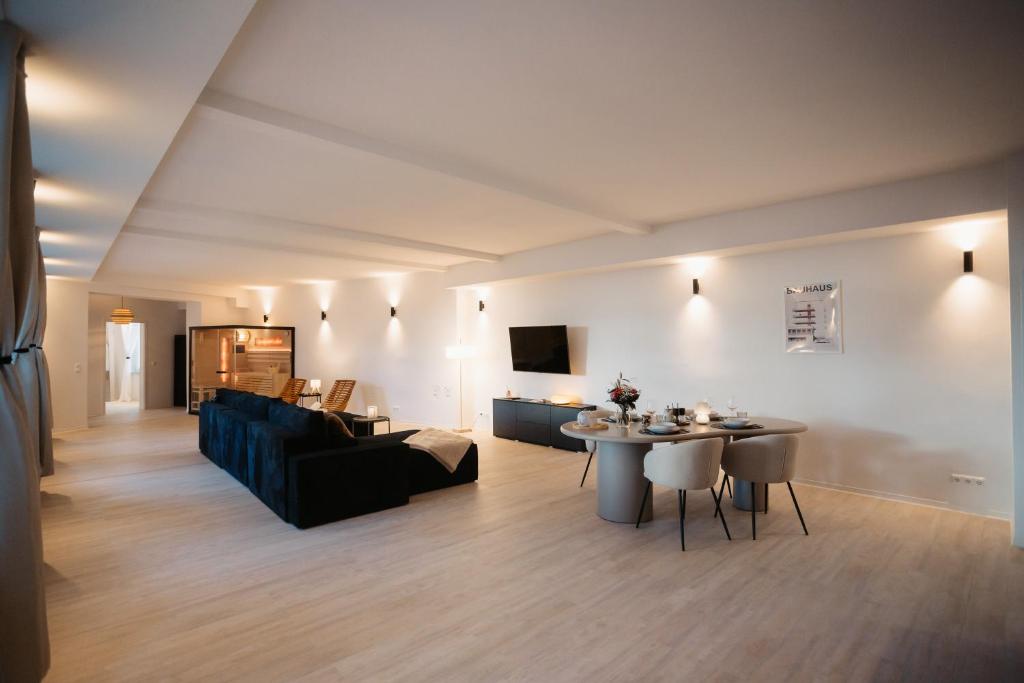 a living room with a couch and a table at Barrierefreies Loft Apartment in Dessau