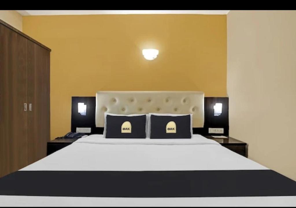 a bedroom with a large bed with two pillows at Hotel The Pal Palace in Nagpur