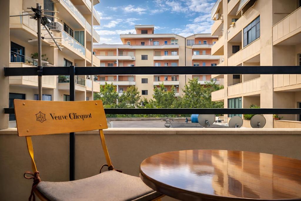 a balcony with a table and a sign on it at EUREKA in Vlorë