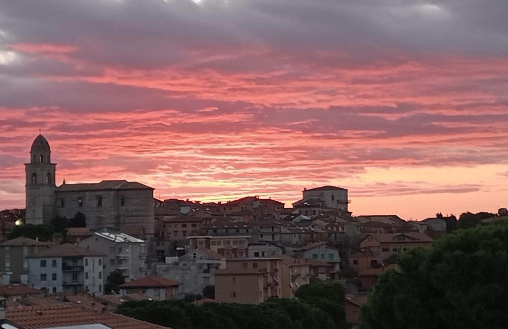 a view of a city with a sunset at Casa Mirabella in Sirolo