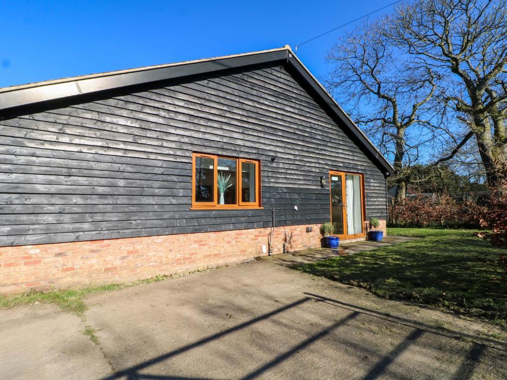 a house with a window on the side of it at Snowdrop Cottage in Maidstone