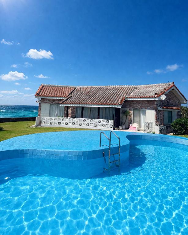 a large swimming pool in front of a house at 478 retreat in Yoron
