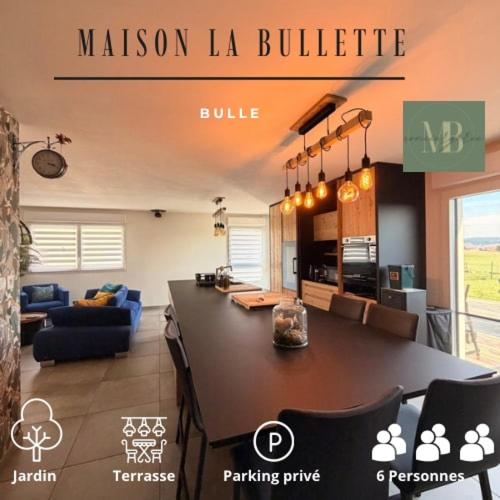 a kitchen and living room with a large counter top at Maison La Bullette à 10 min de Pontarlier in Bulle