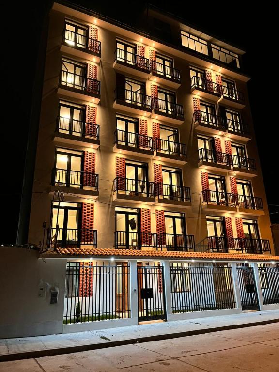 a tall building with lights on the side of it at Hotel Makita in Muquiyauyo
