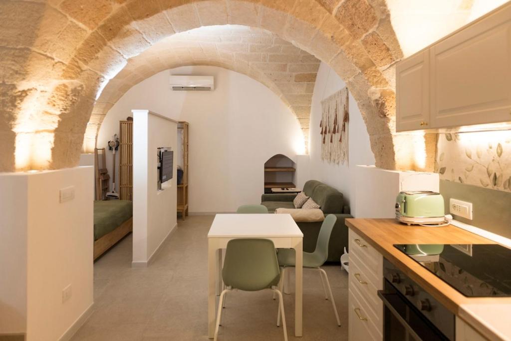 a kitchen and living room with a table and chairs at Suite Bobo in Monopoli