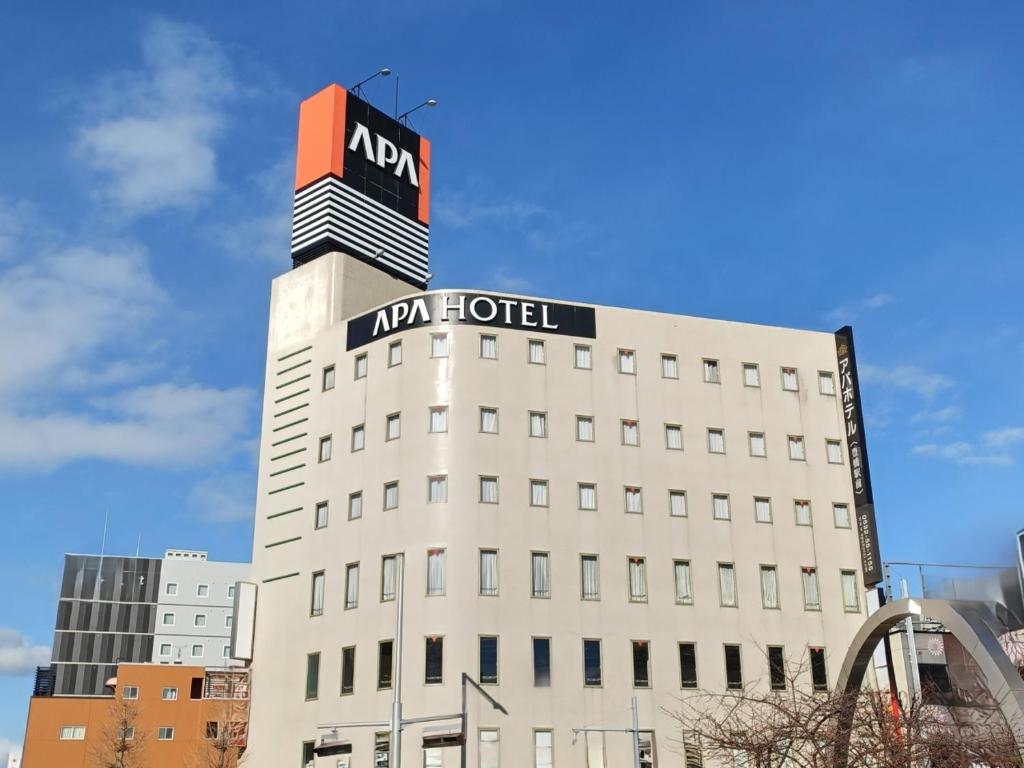 a building with a korean hotel sign on top of it at APA Hotel Toyohashi-Ekimae in Toyohashi