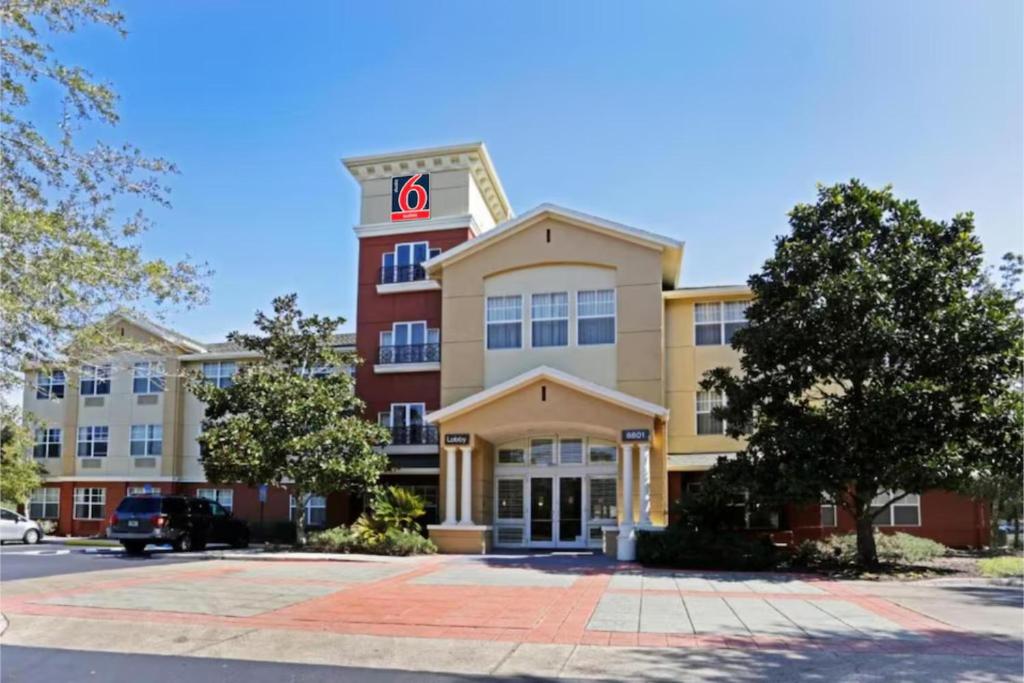 a building with the letter k on it at Studio 6 Suites Jacksonville Deerwood Park FL in Deerwood Club