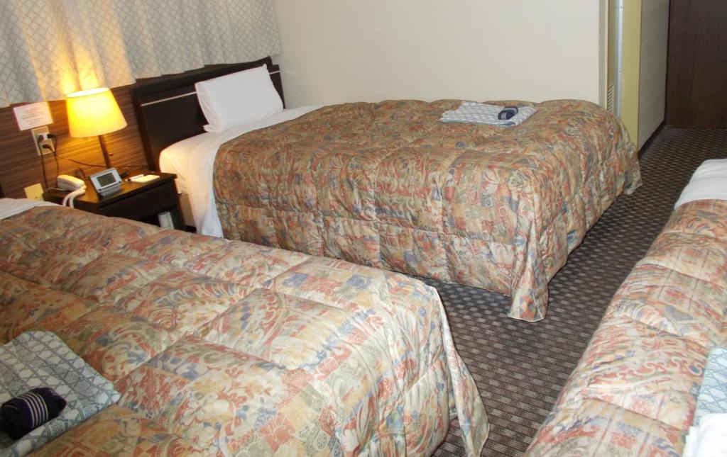 Postel nebo postele na pokoji v ubytování Hotel Matsuyama Hills