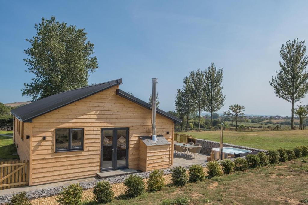 a log cabin with a patio and a backyard at 3 Bed in Adgestone oc-a32613 in Brading