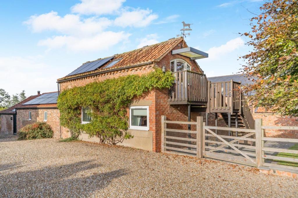an old brick church with a wooden fence at 1 Bed in Crayke oc-g33754 in Crayke