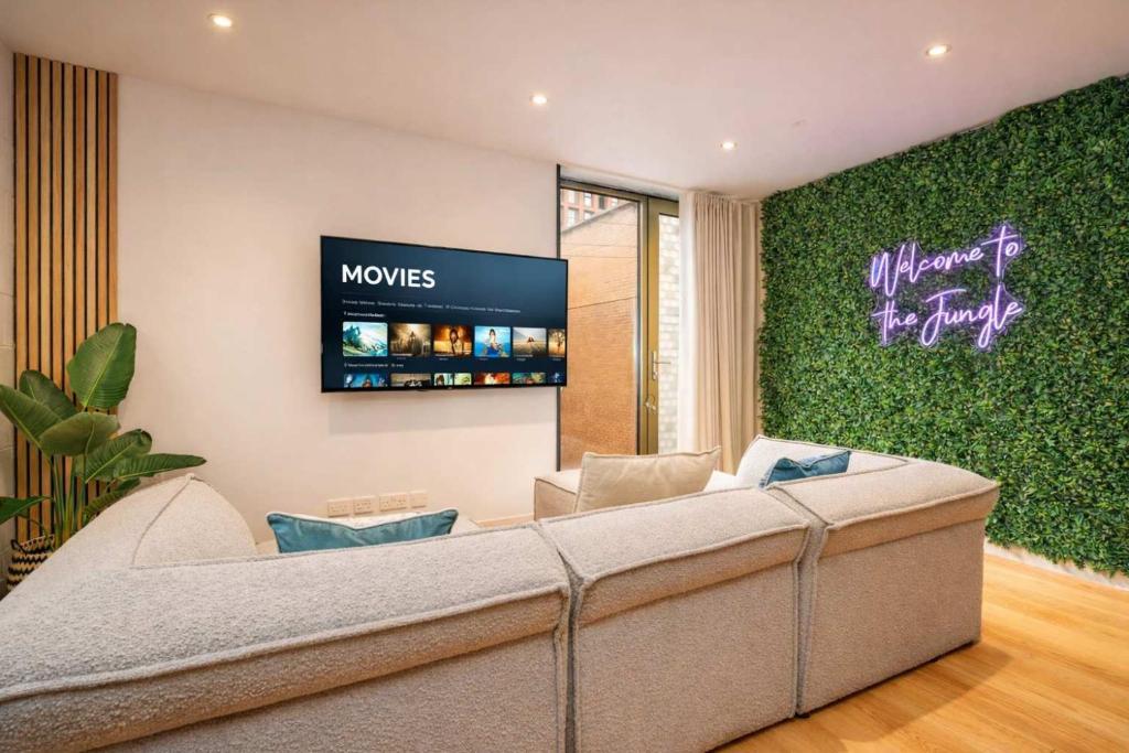 a living room with a couch and a tv at West Townhouse by CasaCity in Manchester