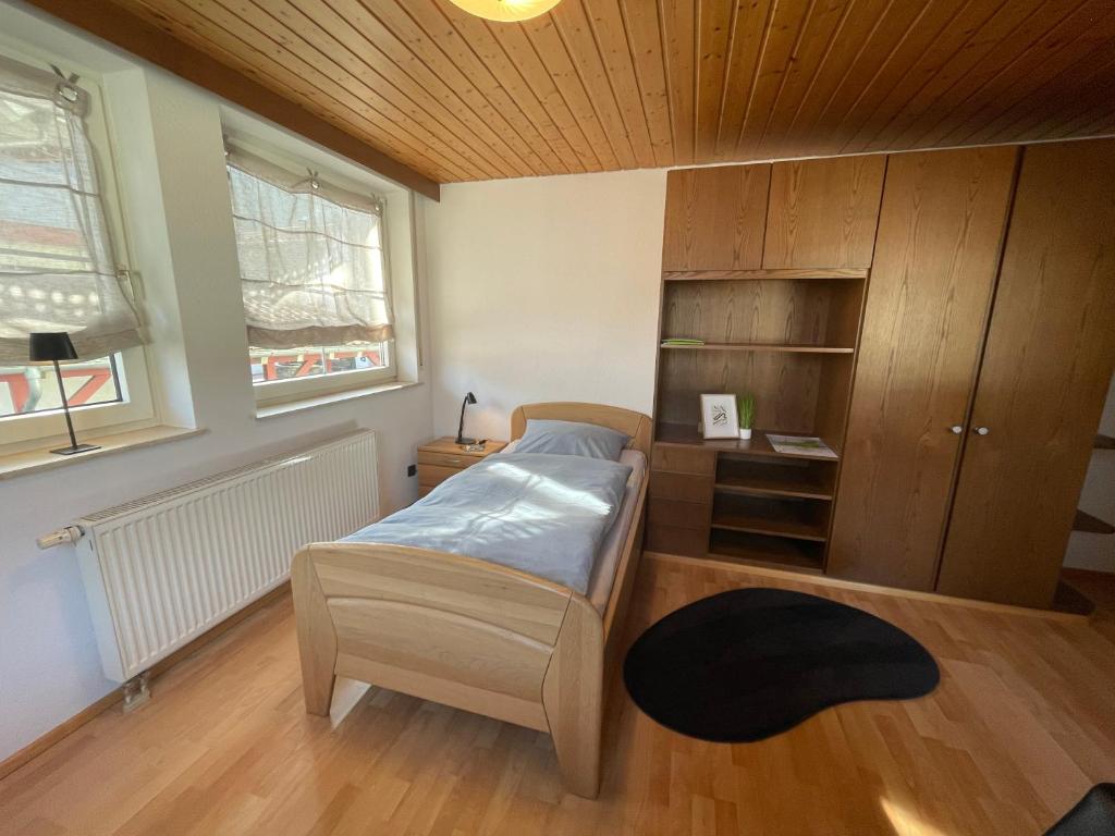 a bedroom with a bed and a wooden ceiling at Appartement an der Steinach in Nagold