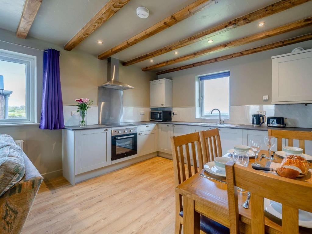 a kitchen with a table and a dining room at 2 Bed in Lancaster oc-53510 in Beetham