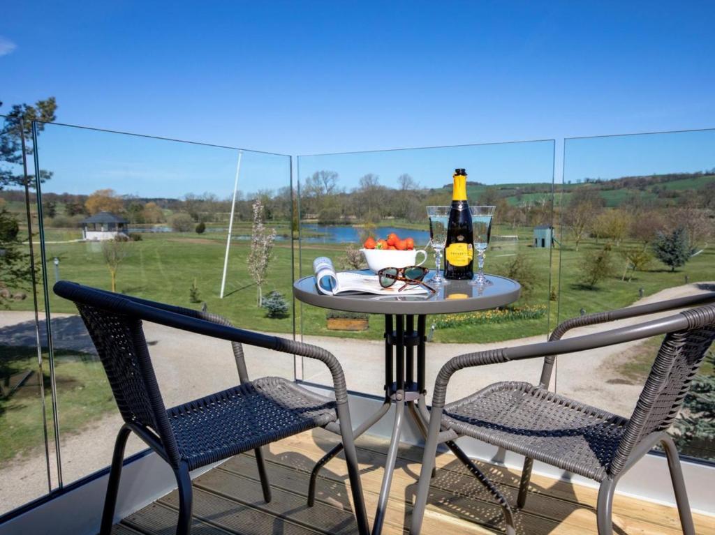 a table with a bottle of beer and two chairs at 1 Bed in Richmond oc-82829 in Gilling