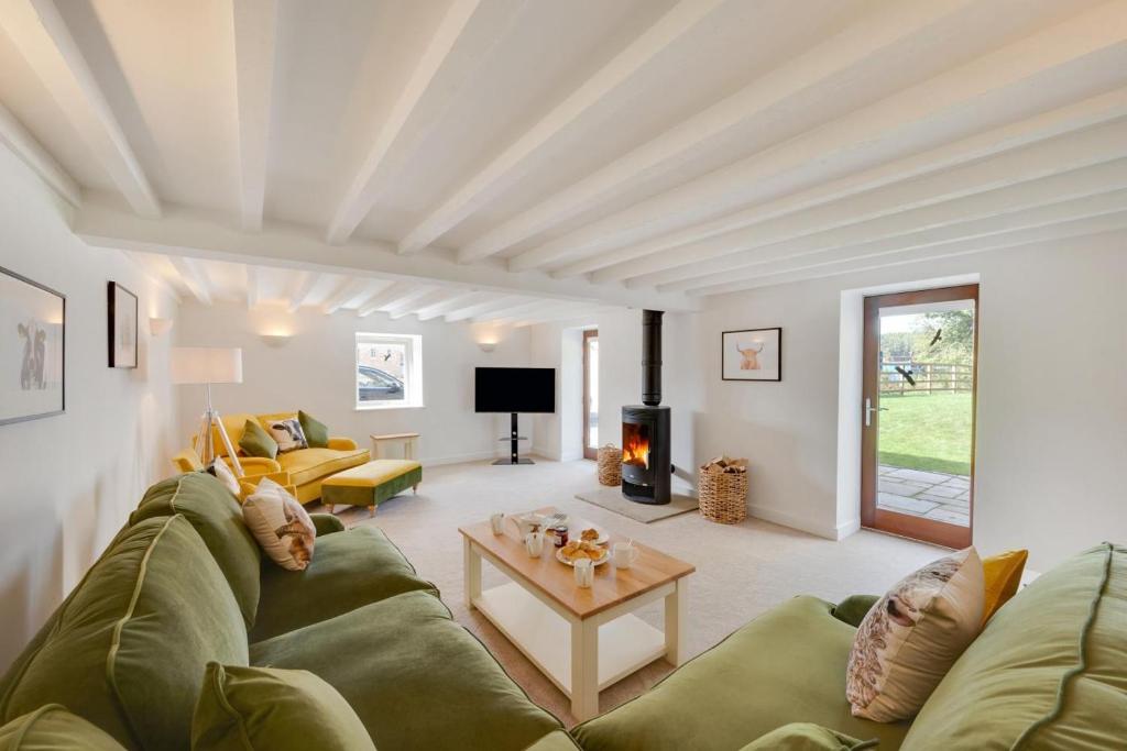 a living room with a couch and a fireplace at 4 Bed in Buxton oc-dcoldd in Hartington