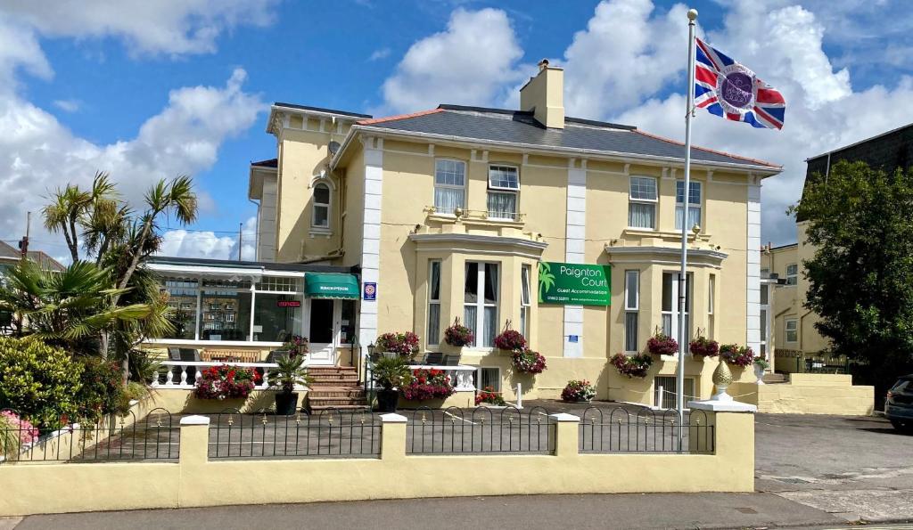 a building with a flag in front of it at Paignton Court in Paignton