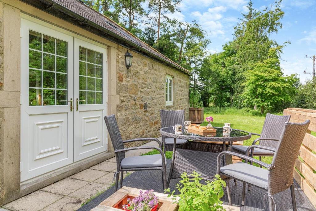 a patio with a table and chairs and a building at 2 Bed in Belsay oc-t29653 in Bolam