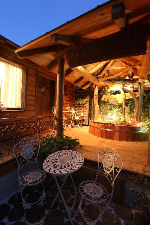 an outdoor patio with two chairs and a table at Srub u Krále in Dobruška
