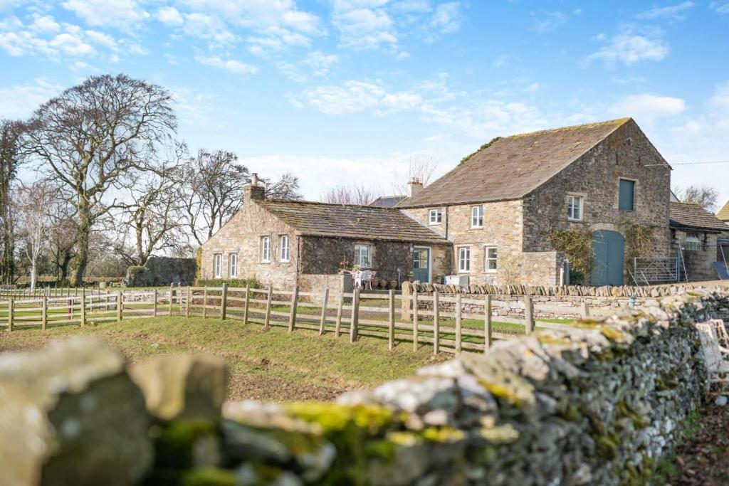 an old stone house with a fence in front of it at 2 Bed in Harmby oc-t30971 in Hornby
