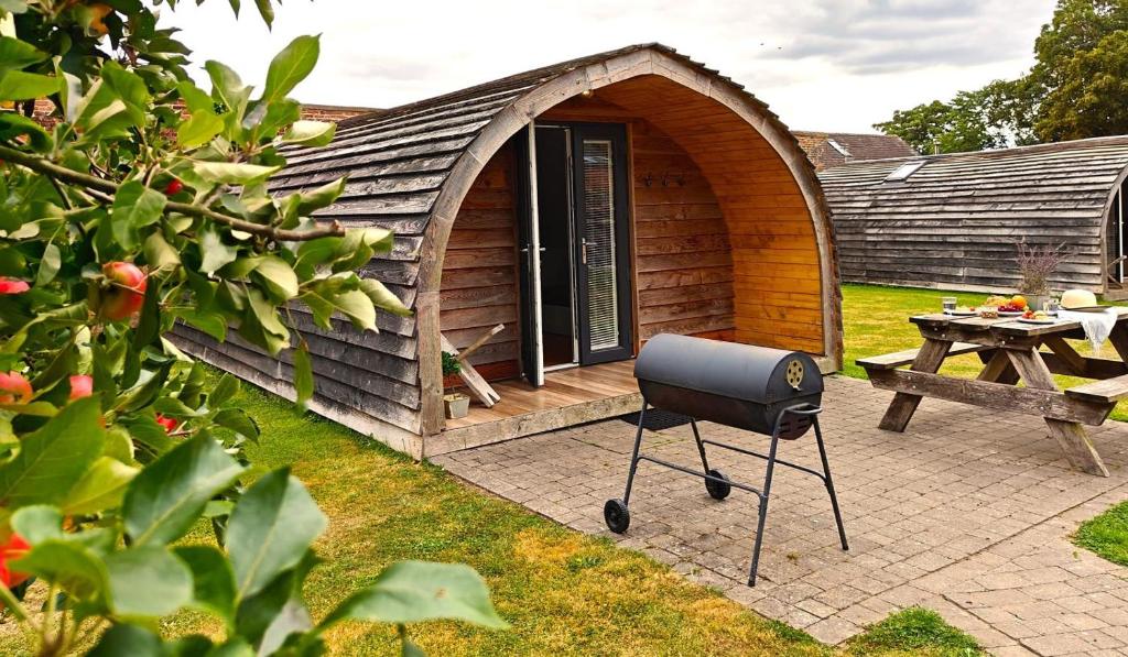 a barbecue grill in front of a small house at 1 Bed in Rocester oc-a33054 in Rocester