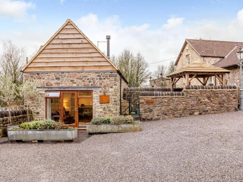 a stone building with a entrance to a house at 1 Bed in Frome oc-83834 in Holwell