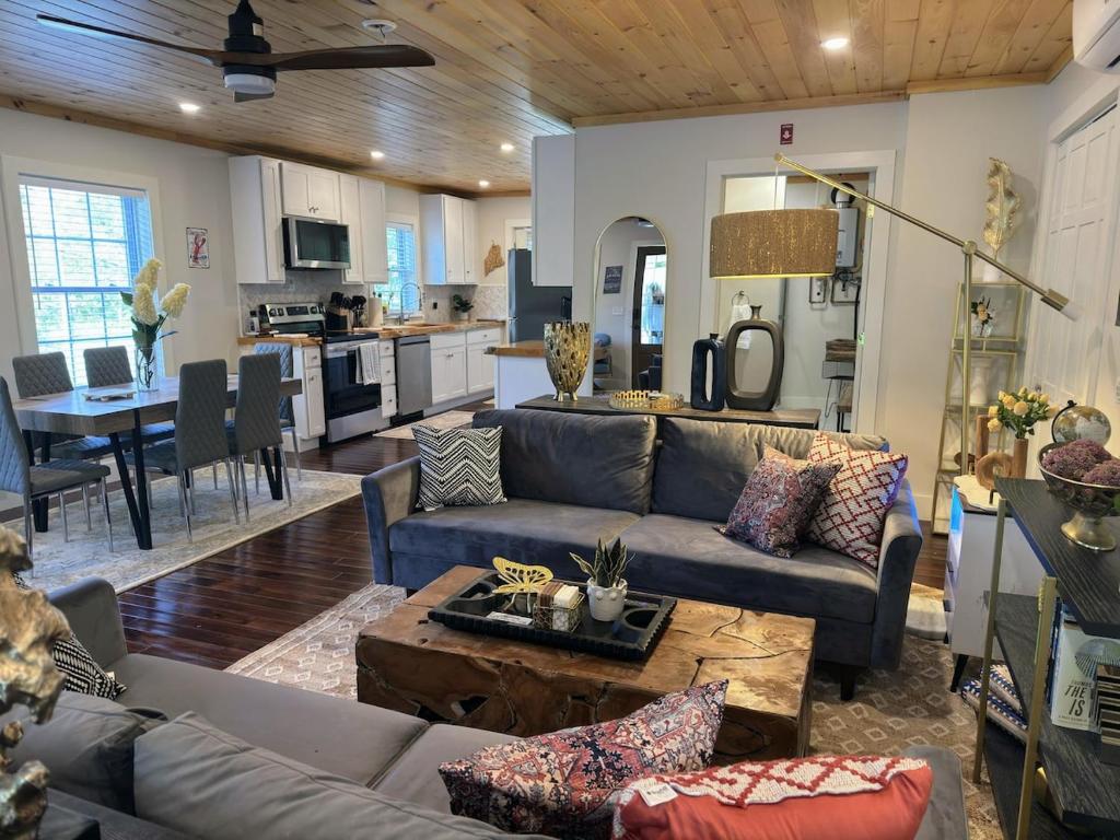 a living room with a couch and a table at 3 Bedroom Happy Cottage 15 in Edgecomb