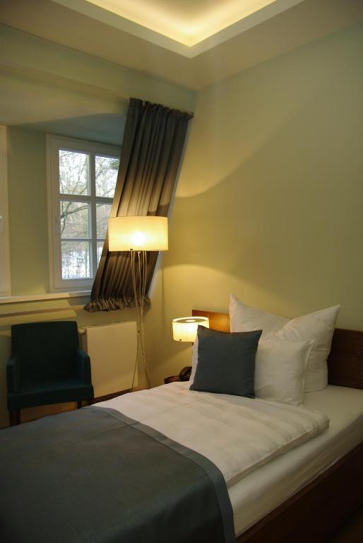 Postel nebo postele na pokoji v ubytování Hotel Schloss Rabenstein