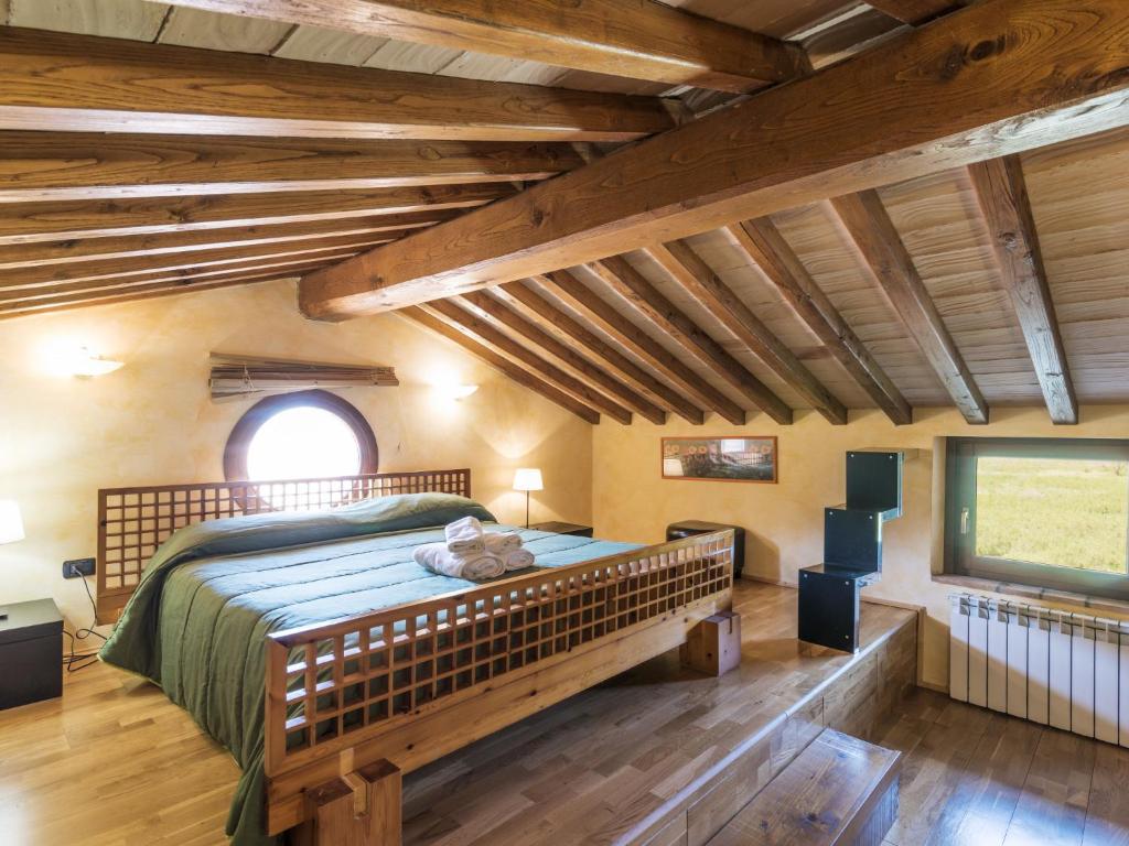 a bedroom with a large bed in a room with wooden ceilings at Apartment Casa Alessandro n-5 by Interhome in Montefiascone